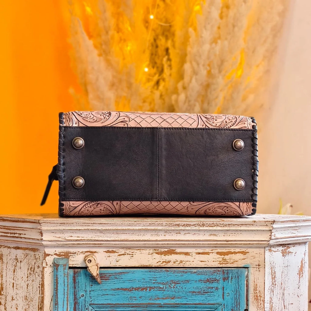 Hand-tooled floral genuine leather weekender trunk, black and beige, with metal feet and braided side stitching.