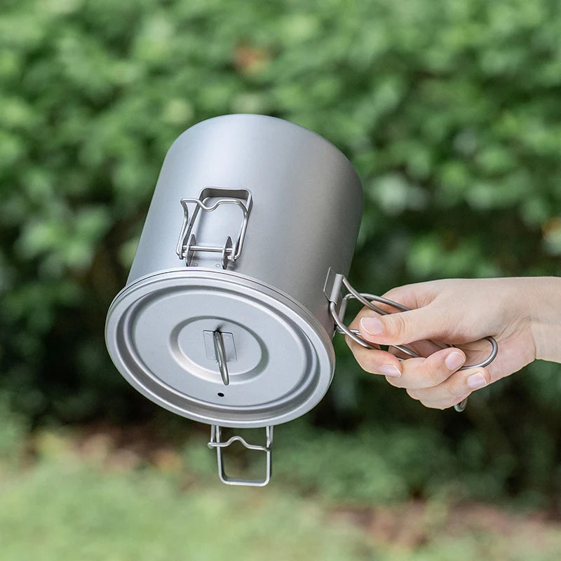 Titanium pot lid with handle and locking clips, silver, close-up
