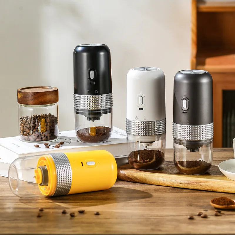 Portable electric coffee grinders in black, white, and yellow with clear containers and textured metal accents.