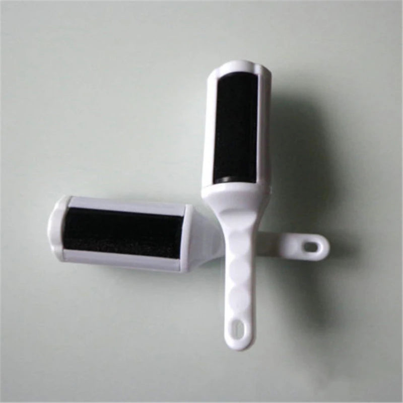 White and black electrostatic pet hair remover brush for efficient cleaning of dog or cat fur from furniture and clothes.