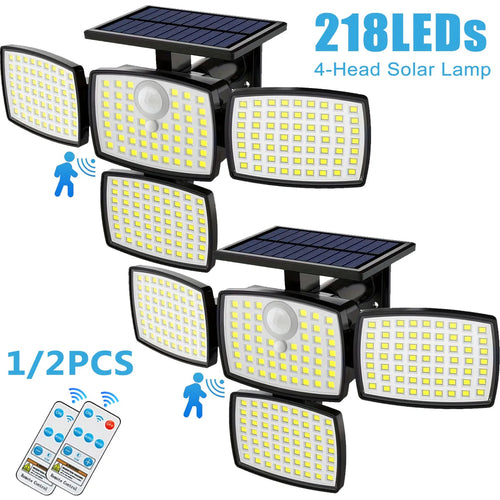 Black 4-head outdoor solar LED flood lamps with top solar panels, motion sensors, and two small remotes.