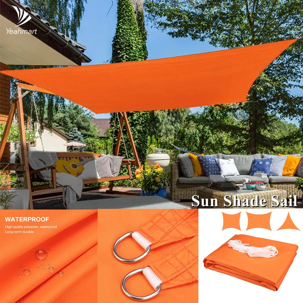 Orange waterproof sun shade sail canopy stretched between posts with corner ties