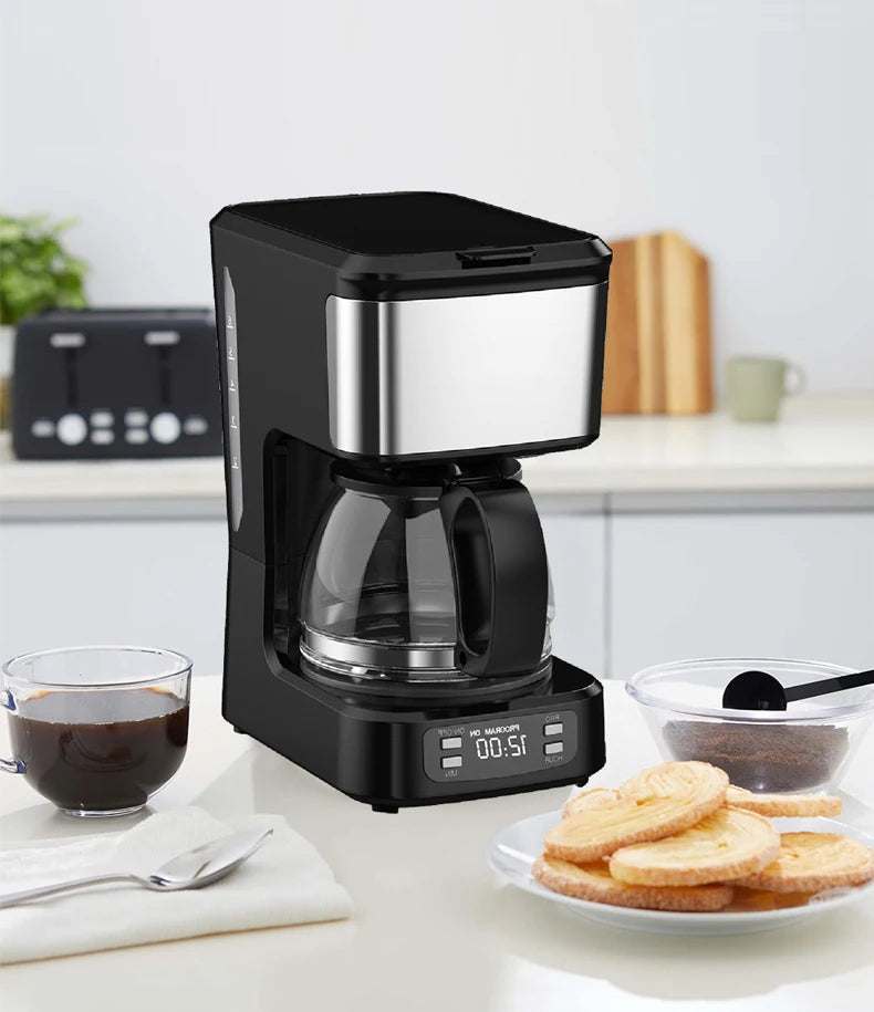 Black programmable drip coffee maker with glass carafe and stainless steel accents on a kitchen counter.