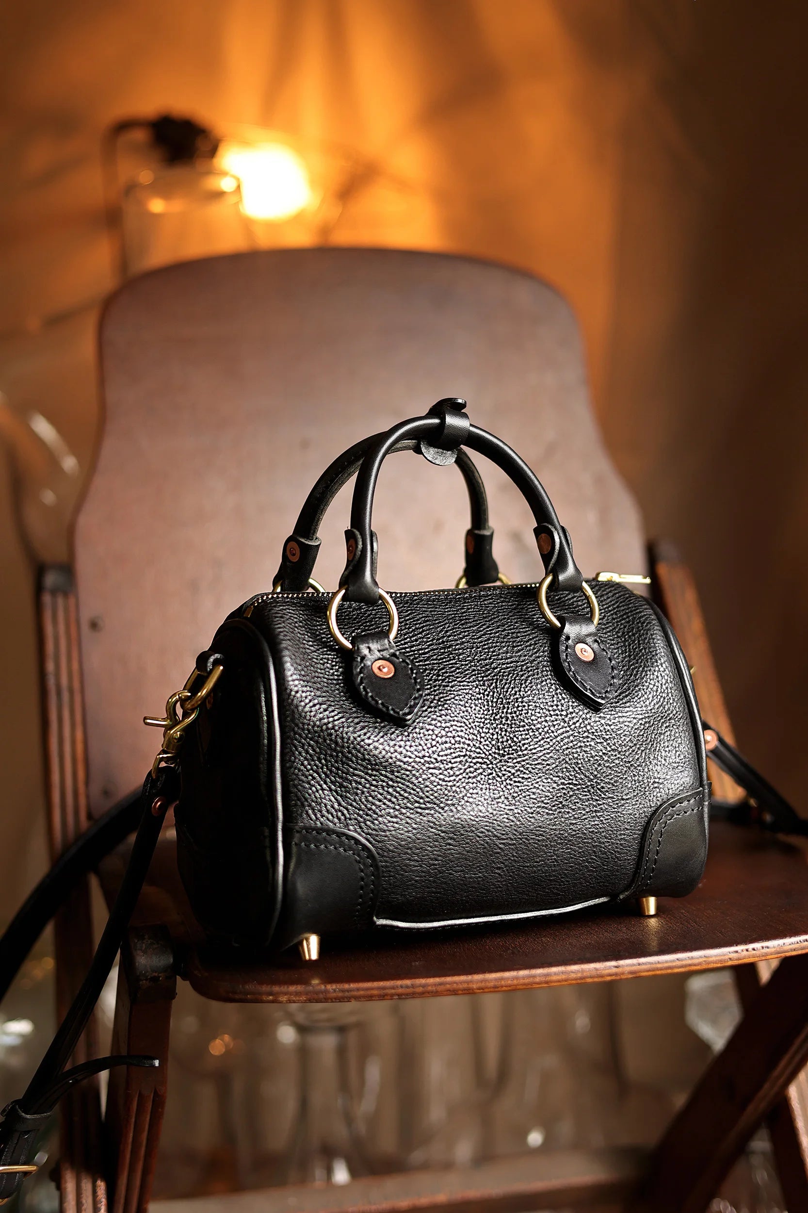 PNDME black genuine cowhide leather small handbag with brass hardware and vintage top-handle design.