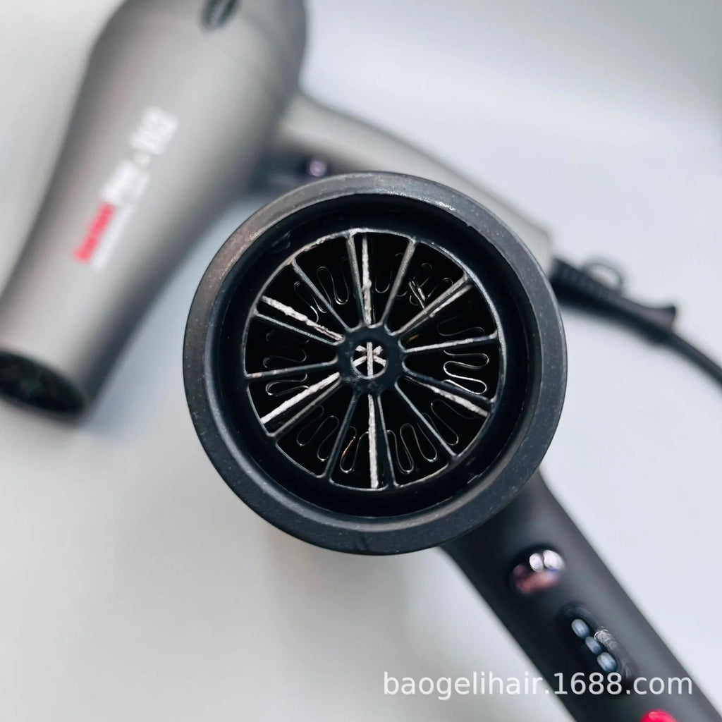 Professional 2600W grey salon hair dryer with high-speed motor and ergonomic heat control buttons for quick drying.