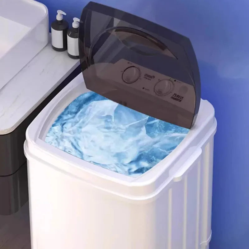 Portable washing machine washing clothes in a compact white and grey top-load design for small spaces.