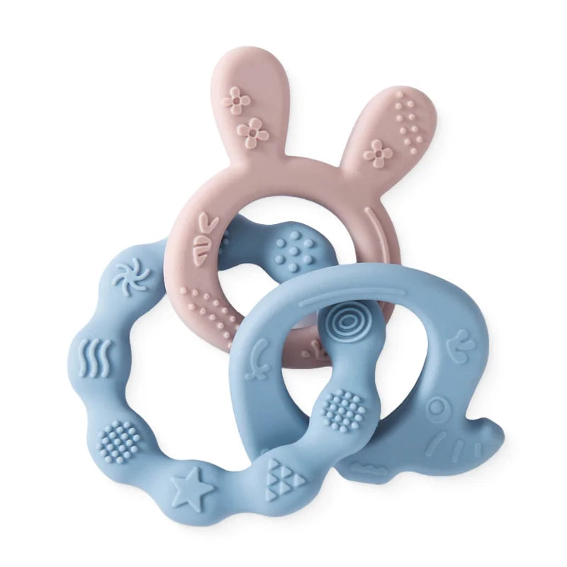 Pink and blue silicone teething rings for baby teething relief. Textured sensory toy set.
