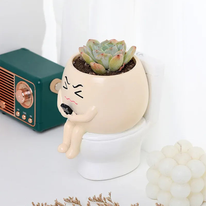 Mini succulent planter character, white with face and blush markings, holding a small succulent.