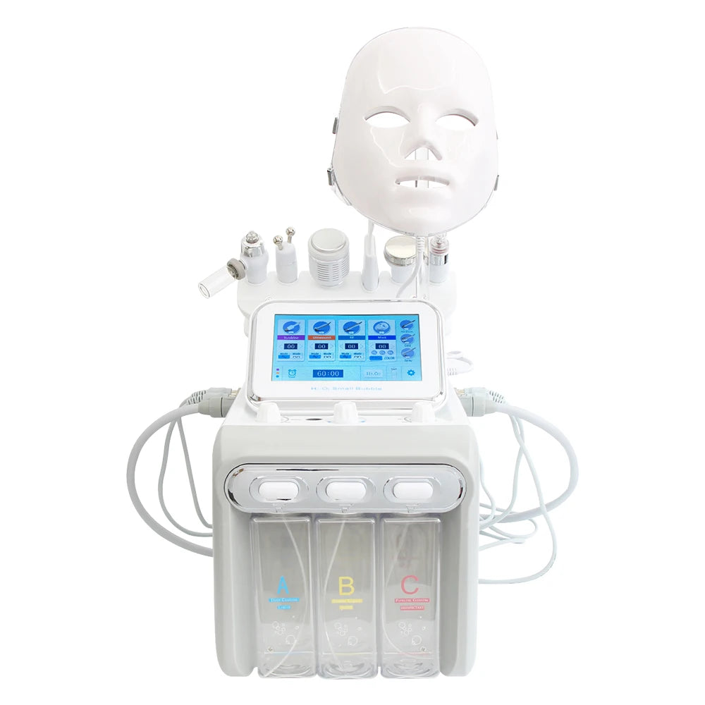 White 7-in-1 hydro dermabrasion spa facial machine with LED light therapy mask, touch screen, and serum canisters.