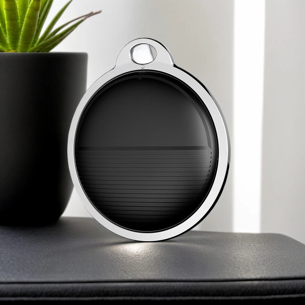 Black and silver mini smart GPS pet tracker for Apple Find My, portable Bluetooth locator for dog or cat collars.