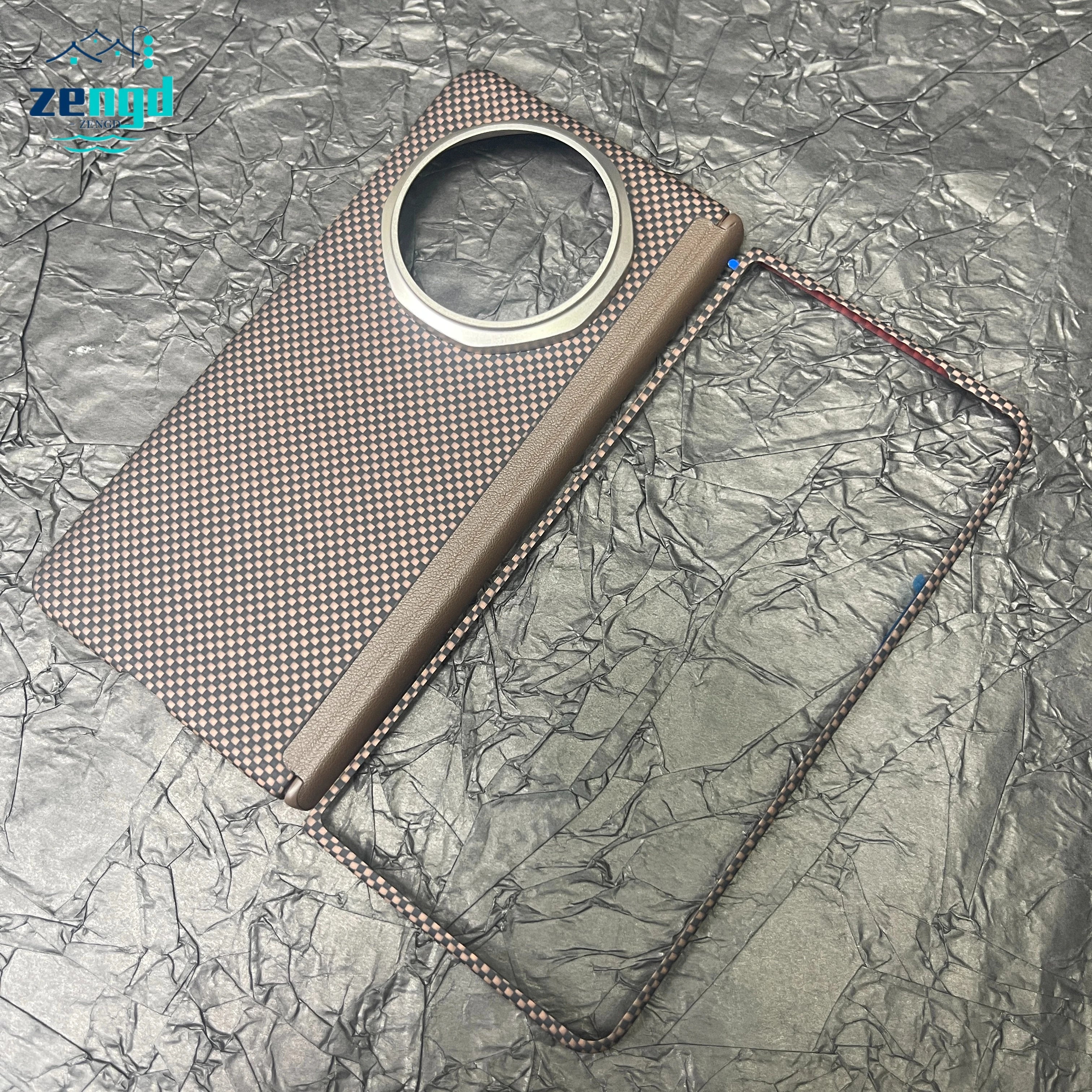Brown checkered carbon fiber phone case with a large circular camera cutout and a separate matching frame border.