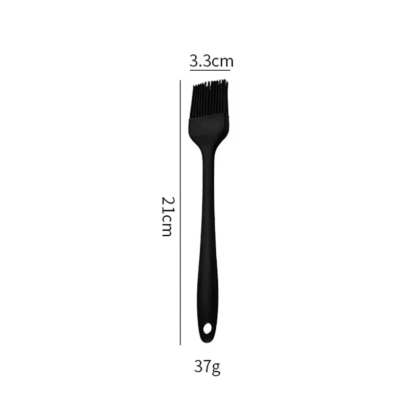 Black air fryer cleaning brush with short bristles and looped handle.