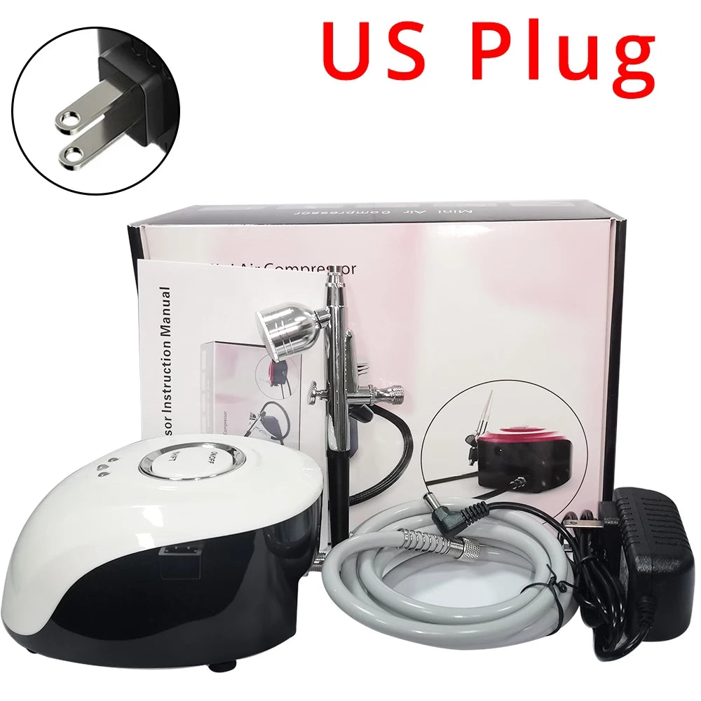 A black and white airbrush compressor kit with a metal airbrush gun, connecting hose, and US plug power adapter.