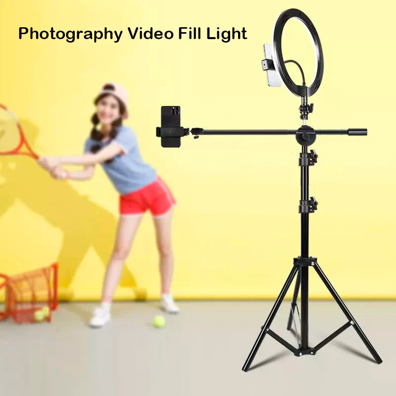 Black metal ring light on a tripod stand with a horizontal phone mount arm for video recording and photography.