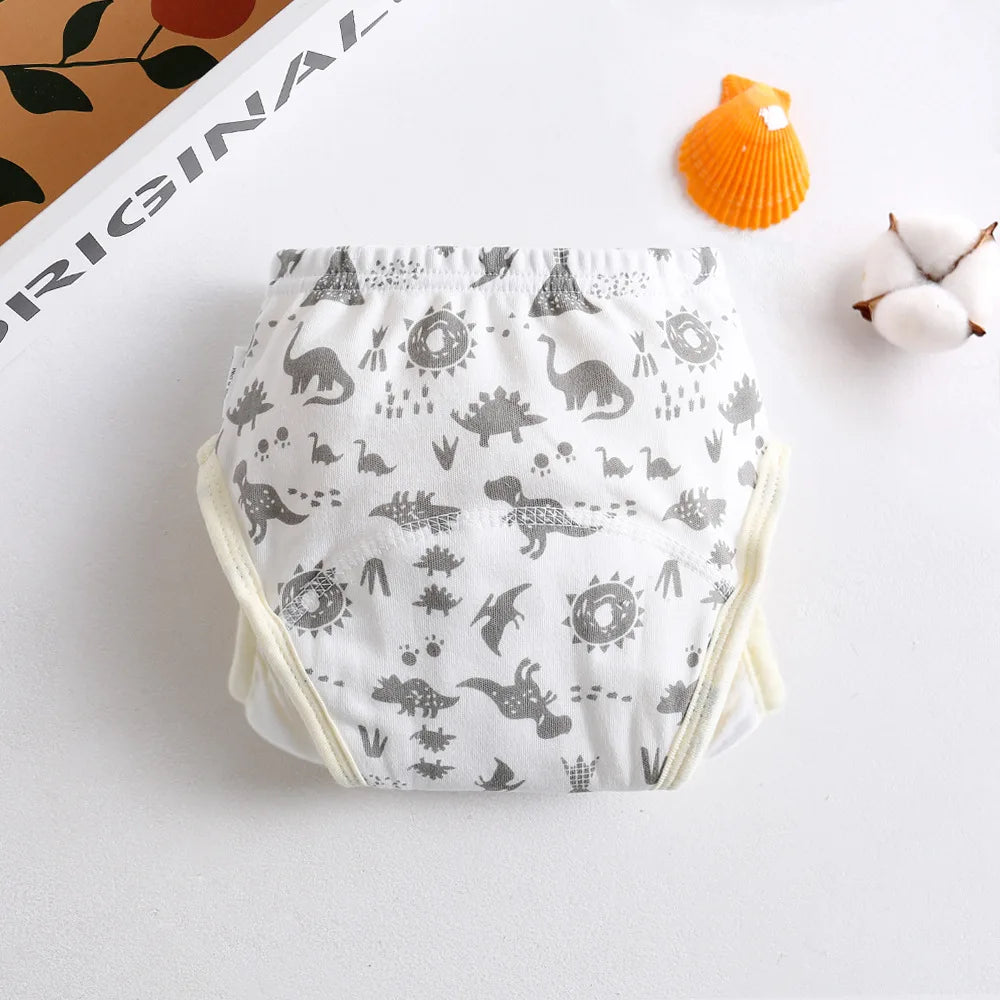 Baby training diaper with grey dinosaur print on white cotton, ideal for toddler potty training.