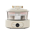 White automatic multi-cooker with stainless steamer basket and glass lid on base