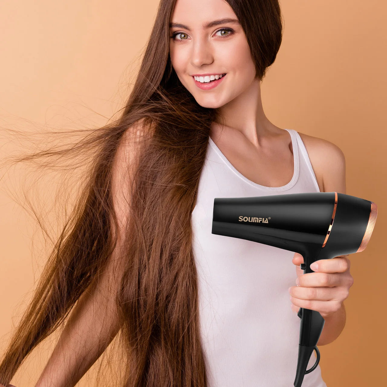 Woman using a professional black and rose gold salon hair dryer for quick, high-heat styling at home.