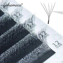 Black 12mm eyelash extension clusters on a tray for professional lash application.