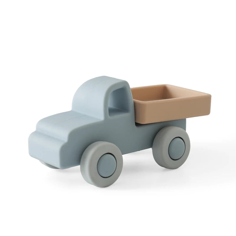 Blue and beige silicone truck baby teething toy for soothing sore gums.