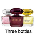 Three 50ml Vercage perfume bottles with faceted diamond-shaped caps in pink, deep purple, and yellow glass.