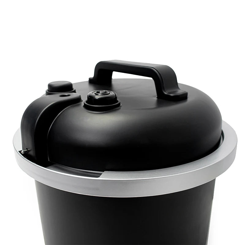Black electric pressure cooker with side handle and lid open on a base
