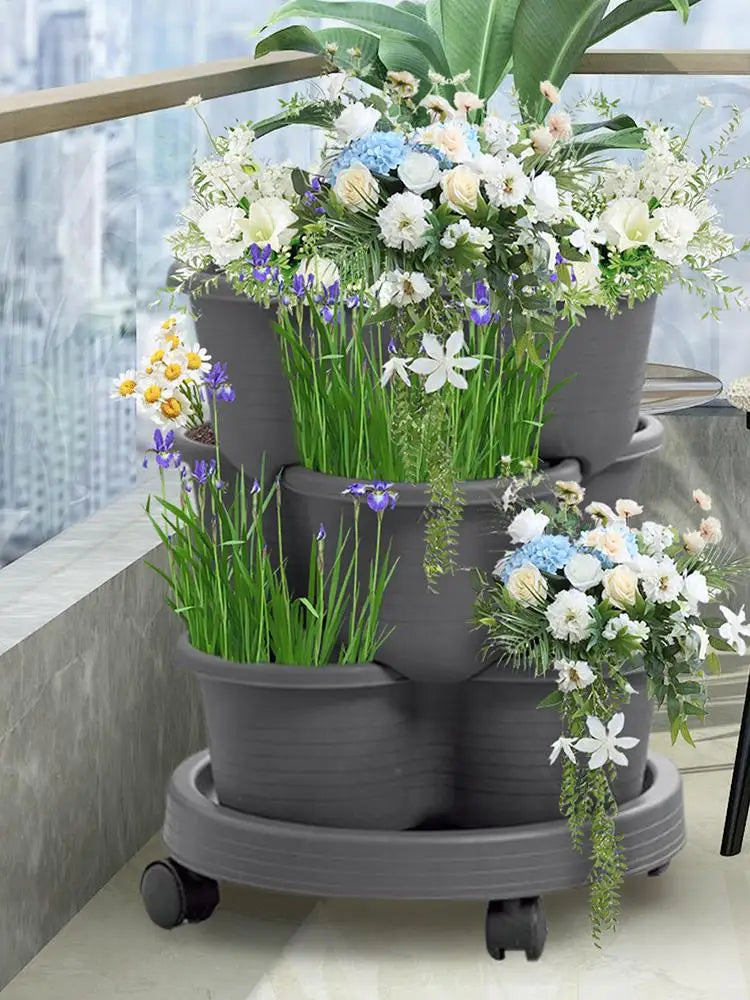 Dark gray 3-tier planter tower with potted flowers, stacked on rolling base