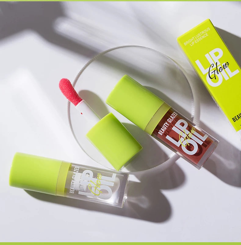 Moisturizing candy lip gloss with a lustrous mirror finish and doe-foot applicator in neon green packaging.