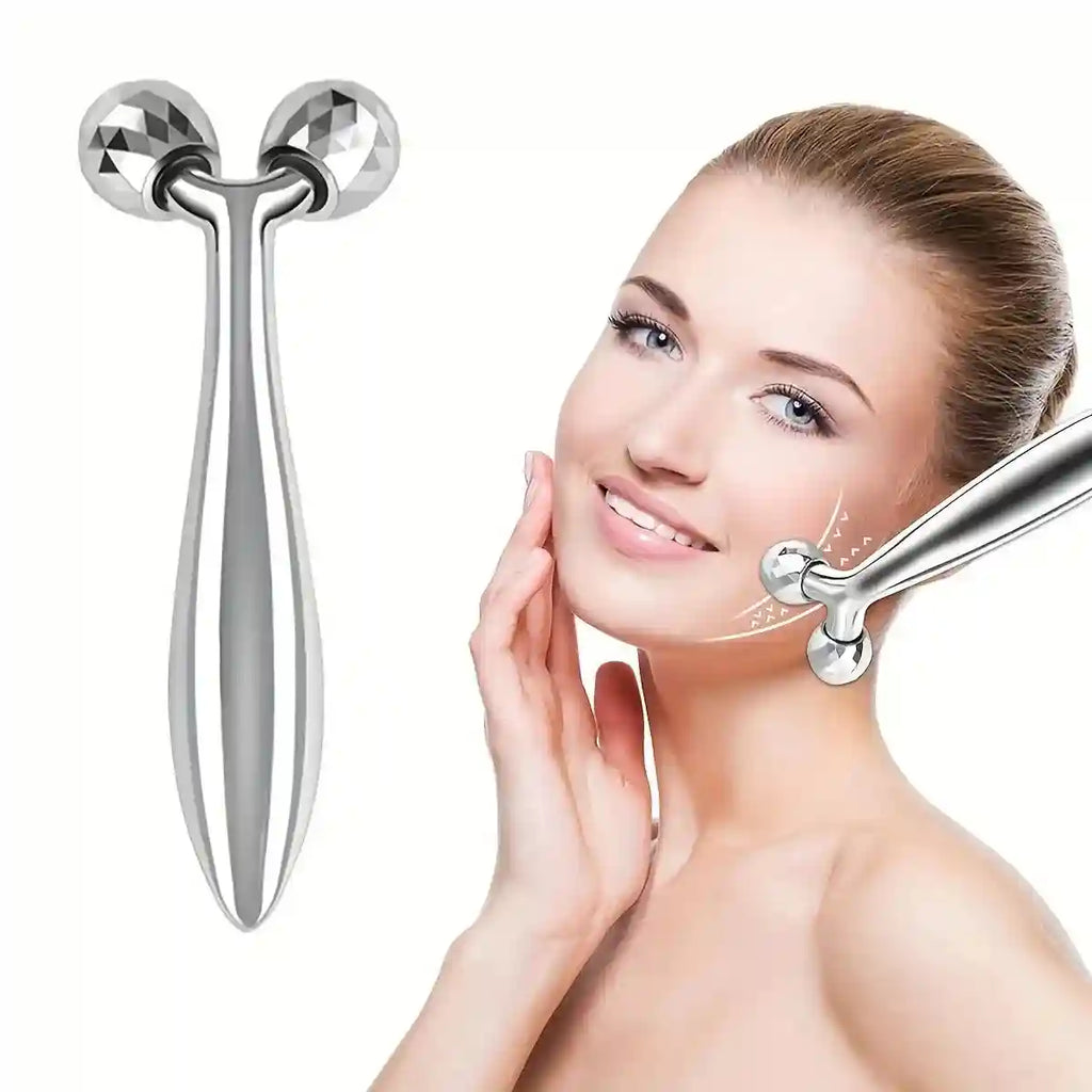 Silver Y-shaped 3D facial roller massager with diamond-cut spheres being used on a woman's jawline.