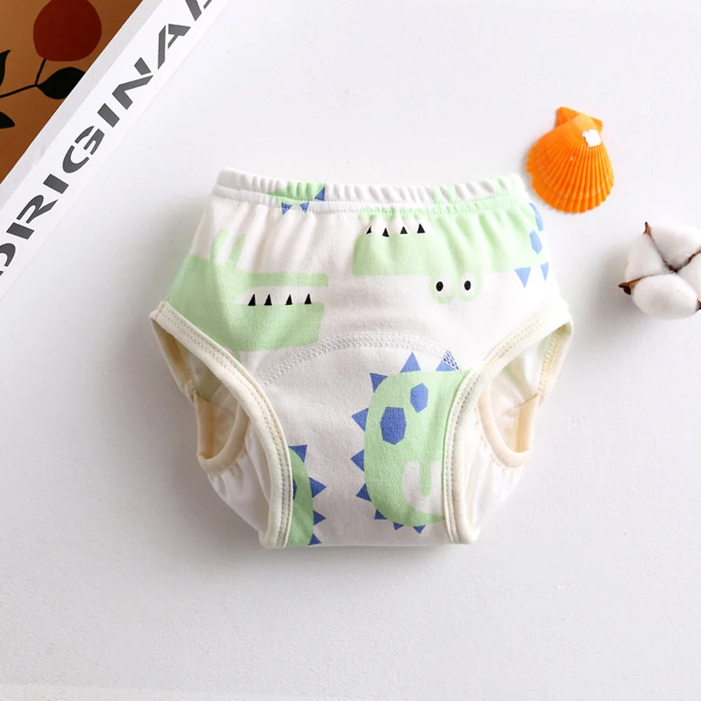 Cotton baby training diaper with cute green dinosaur print for potty training.