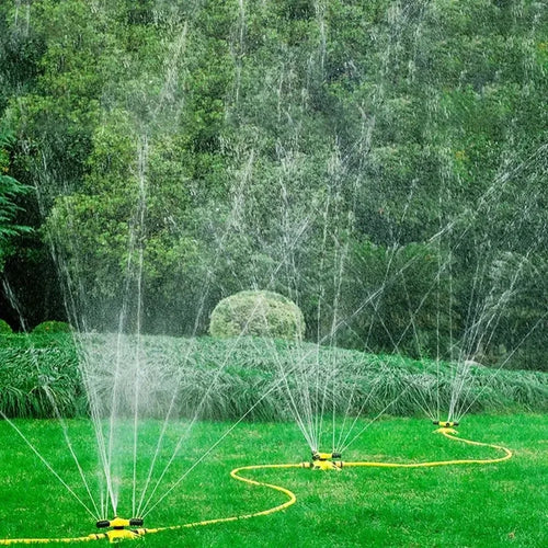Garden lawn sprinkler set with three rotating heads over a yard lawn, yellow and black