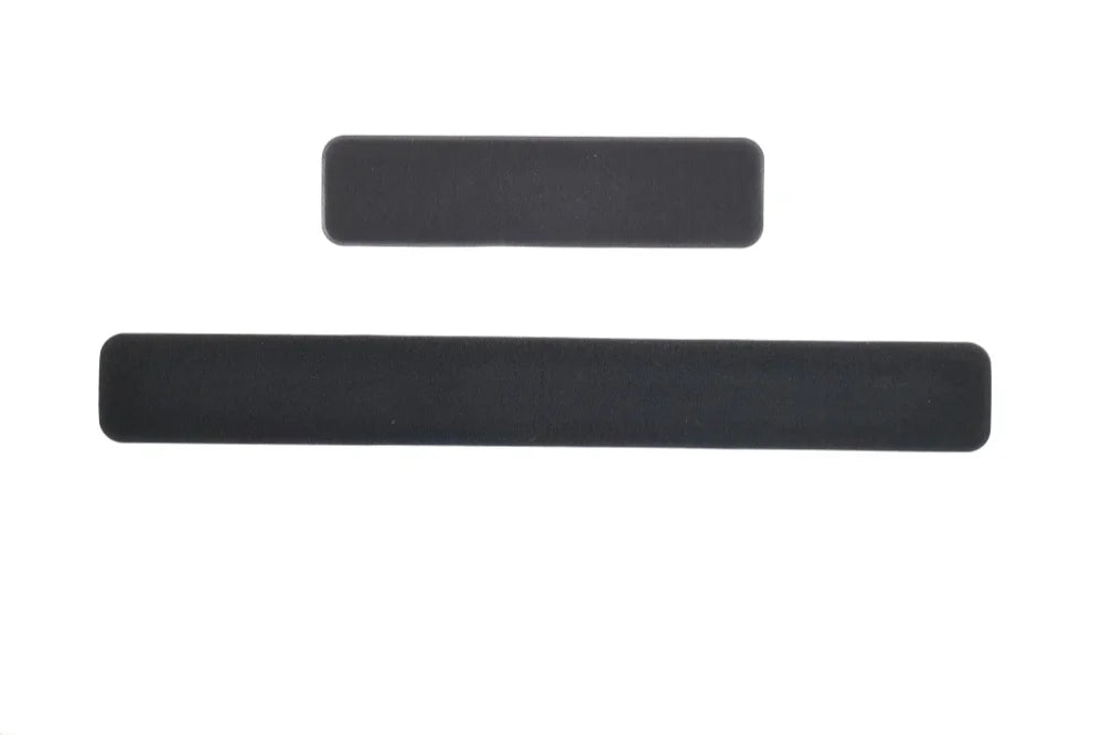Two rectangular, smooth black silicone strips of different lengths isolated on a white background.