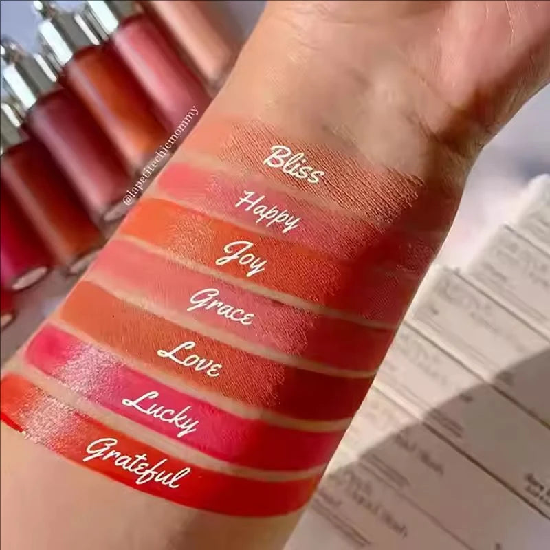 Rare Beauty Soft Pinch Tinted Lip Oil swatches on skin showing glossy, hydrating textures in diverse pigmented shades.