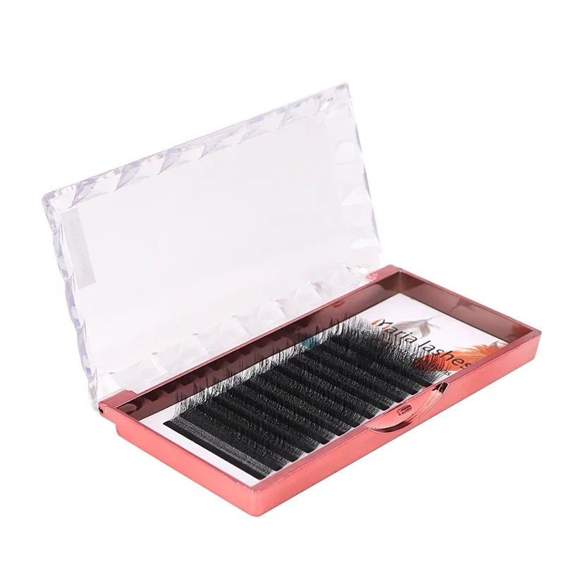 Black 3D W-shaped lash extensions in a reflective pink case with a clear, faceted flip-top lid.