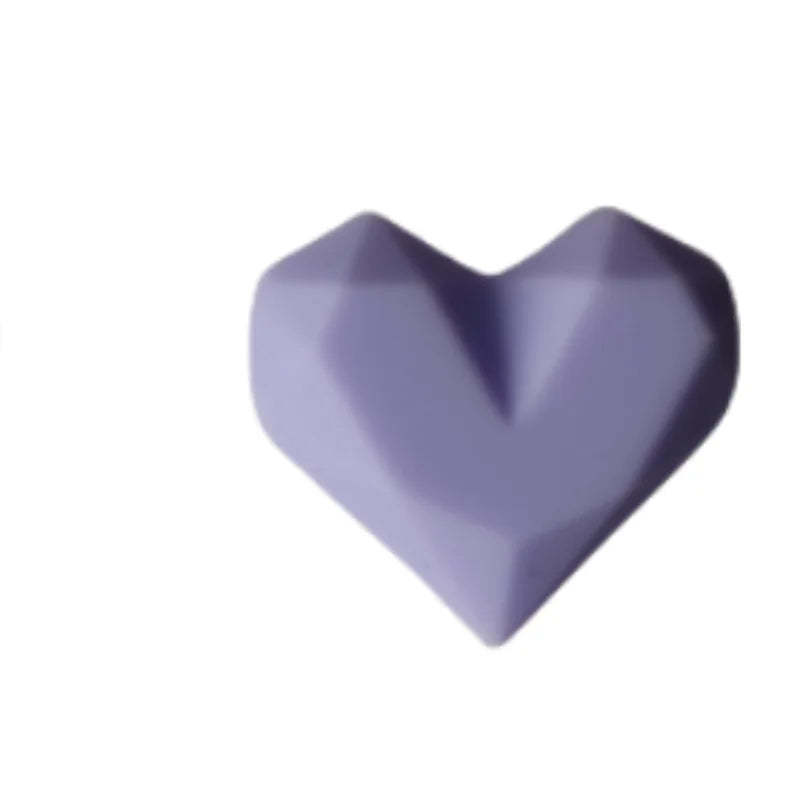 Purple silicone heart dust plug for Tamagotchi Uni. Protect your electronic pet port with this stylish, durable cover.