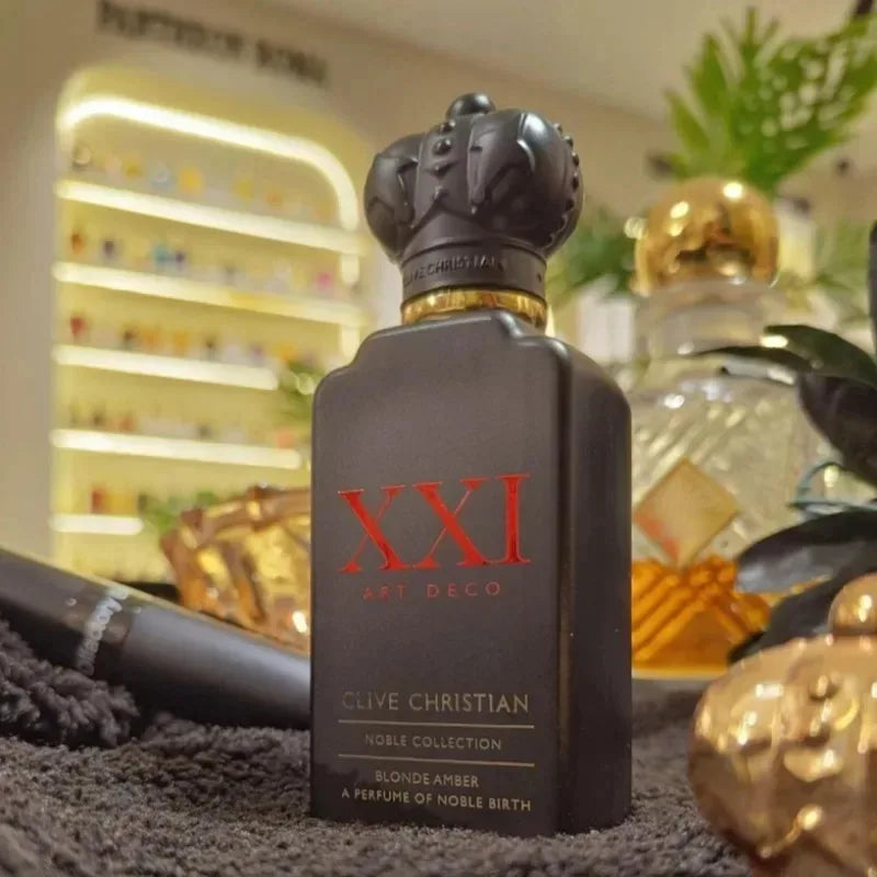 Matte black rectangular perfume bottle with red text, a crown-shaped cap, and gold neck detailing.