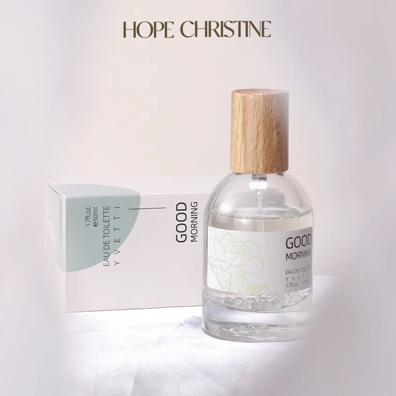 Pure Gardenia niche perfume bottle with wood cap and minimalist floral label next to box on a soft white background.