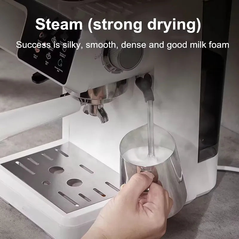White espresso machine with stainless steel steam wand frothing milk in a metal pitcher for silky foam.