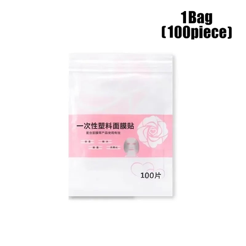 A pack of 100 clear disposable plastic face mask sheets in a white pouch with a pink label and rose graphic.