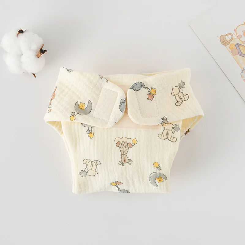 Soft muslin baby diaper with cute bear and moon print, adjustable velcro closure for gentle baby care.