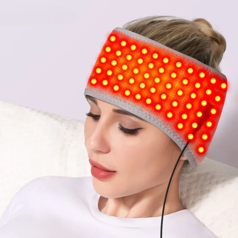 Person wearing a heated red light therapy headband for migraine relief and stress reduction on a white background.