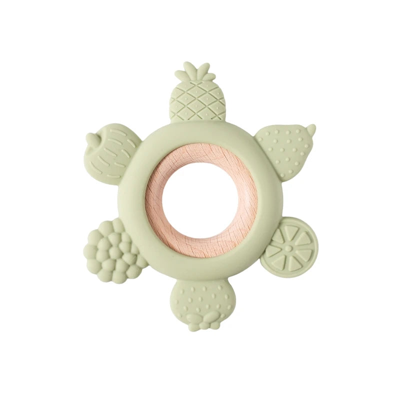Sage green silicone and wood fruit baby teething ring for teething relief.