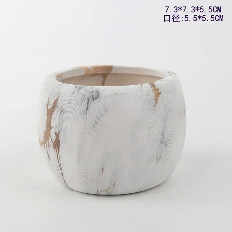 Ceramic succulent pot with white marble-look finish and tan/gold splash accents