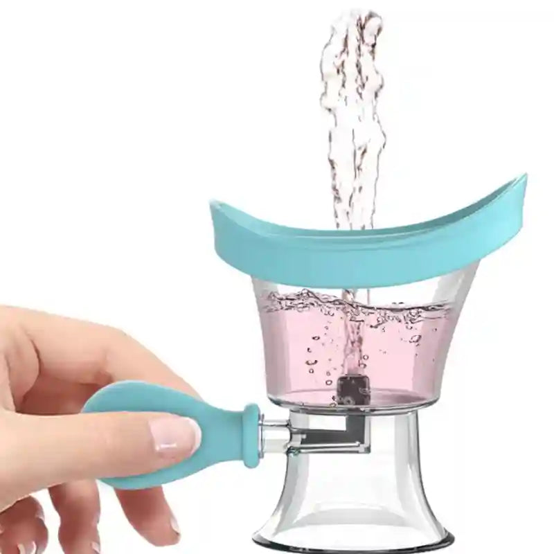 Handheld blue silicone eye wash cup with clear reservoir, demonstrating water rinsing flow for effective eye cleaning.