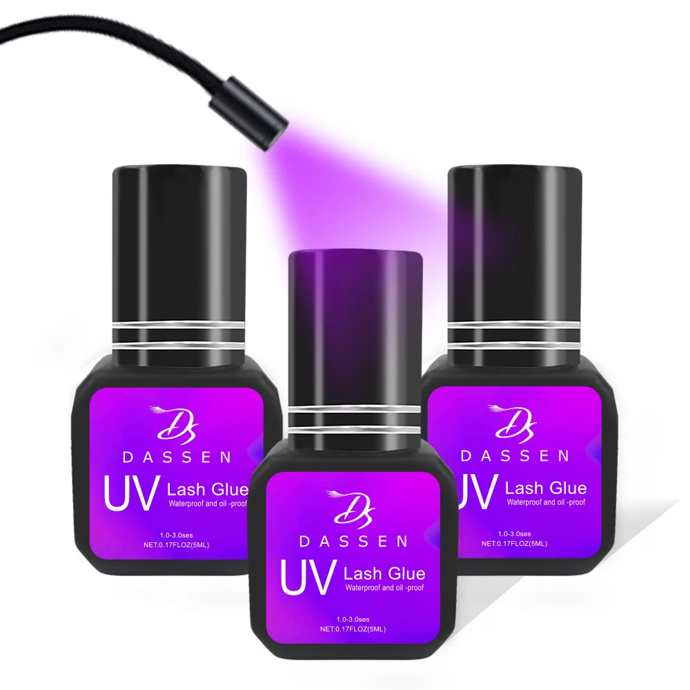 Dassen 5ml UV Eyelash Extension Glue in black bottles with purple labels under a UV curing light.