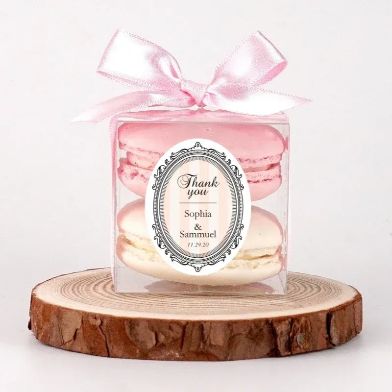 Thank you custom label sticker on a clear gift box with pink ribbon and macarons.