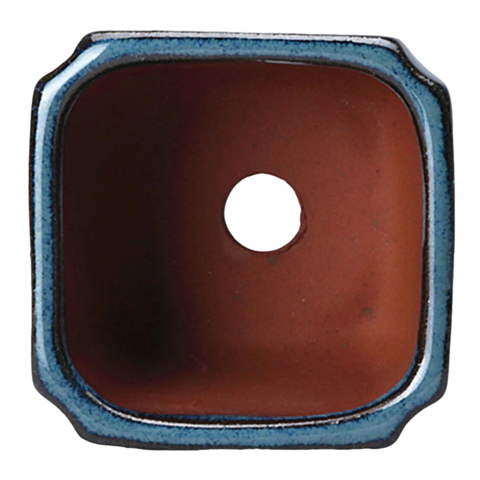 Blue glazed ceramic pot top opening with terracotta interior and circular vent hole