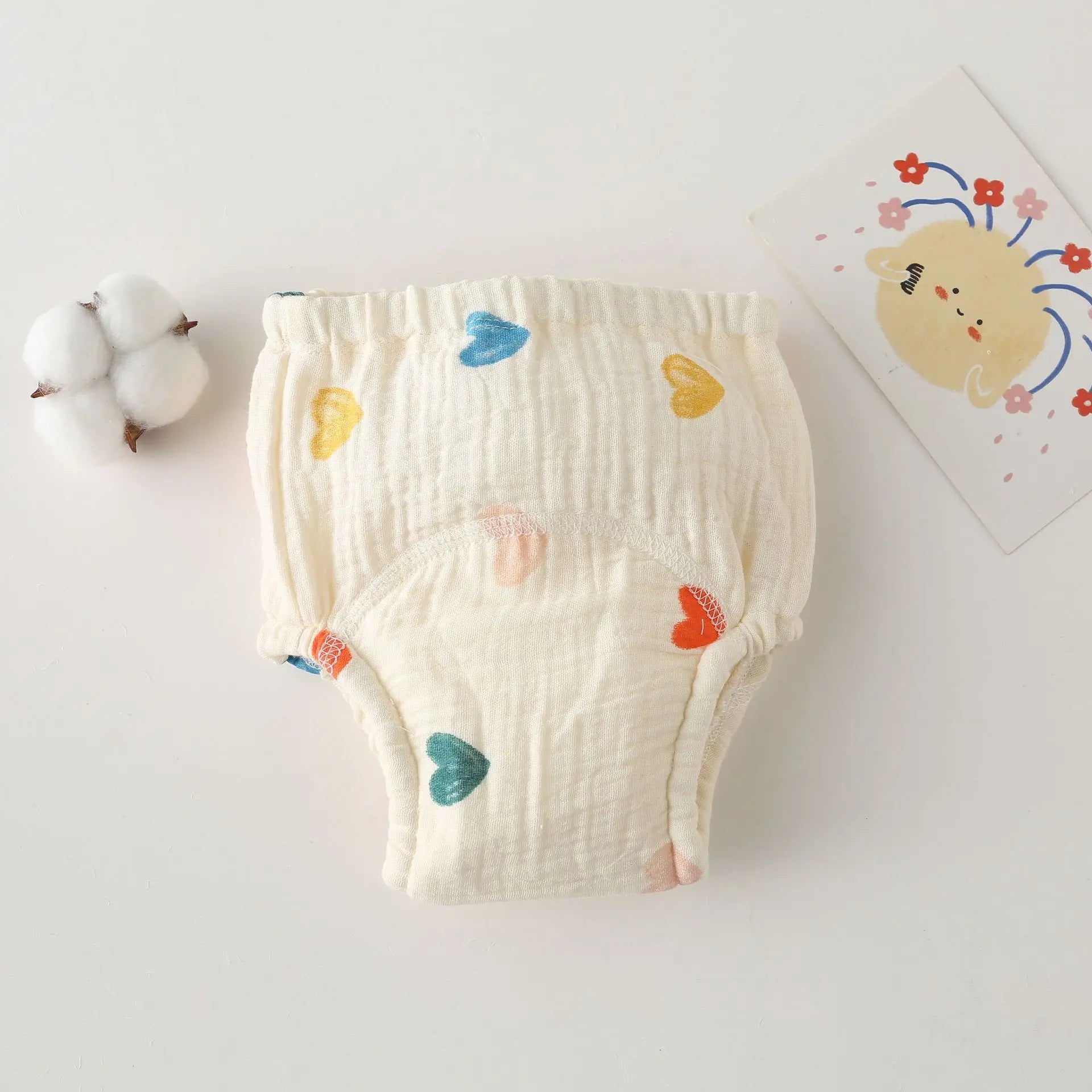 Baby care cotton training diaper with colorful heart print pattern.