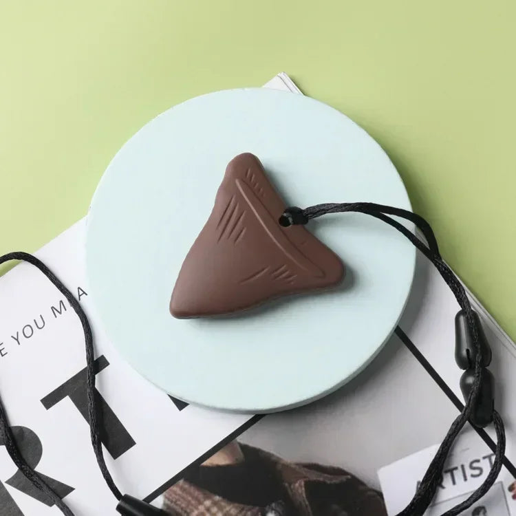 Brown silicone baby teething toy on a necklace for safe relief.