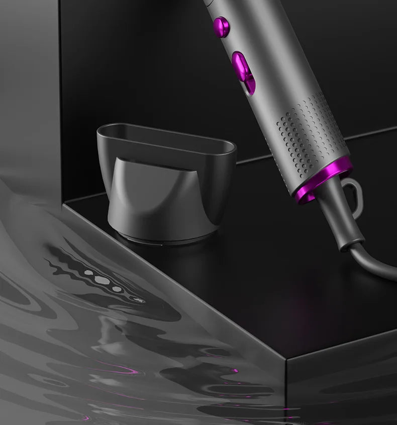 Foldable negative ion hair dryer in grey with purple buttons and salon-style styling nozzle attachment.