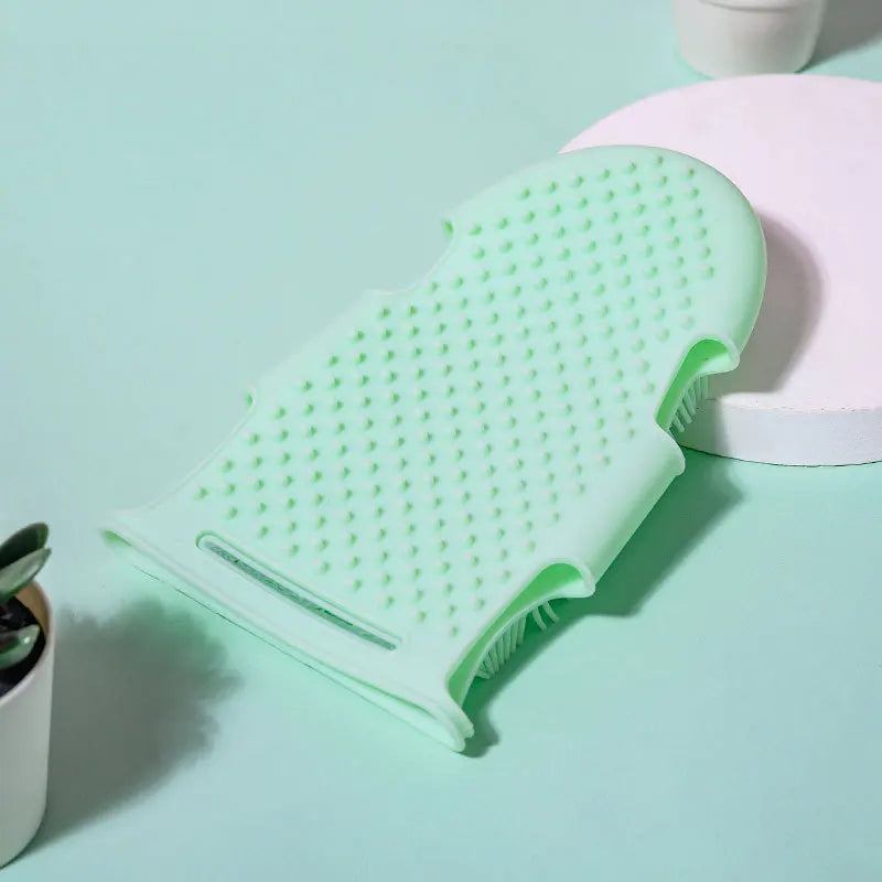 Mint green silicone pet bath glove and massage brush for gentle cleaning and shedding removal.